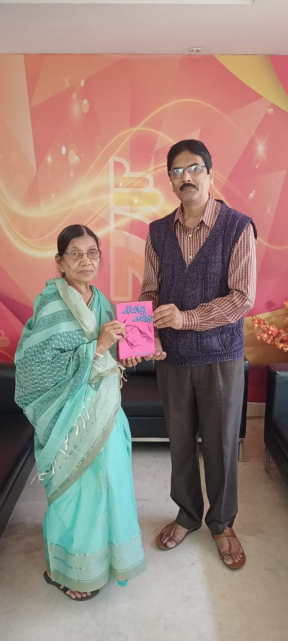 Basanta Kumari Samanta presenting a copy of her poetry book to an admirer